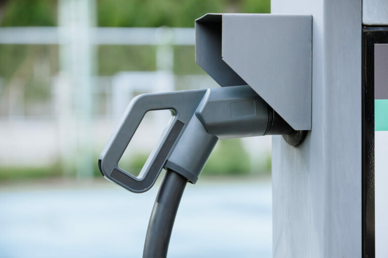 Closeup electric car charger head plug for charging EV car at ev charger station