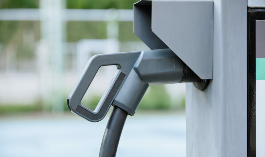 Closeup electric car charger head plug for charging EV car at ev charger station