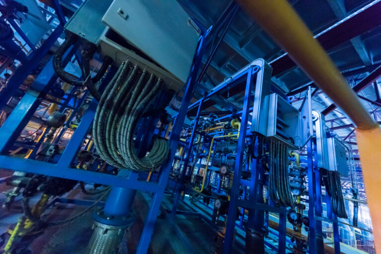 Factory workshop interior and machines on glass production background