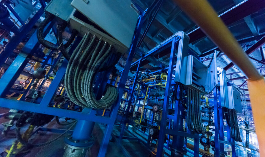 Factory workshop interior and machines on glass production background