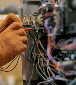 Male electrician hands repairing coffee machine in workshop. High quality photo
